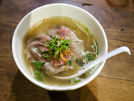Pho bo , Vietnamese food , rice noodle soup with sliced rare beef 