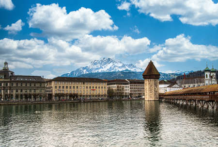 LUZERN, SWITZERLAND - APRIL 11:Chapel bridge famous place on lake Luzern with snow mountain behide, APRIL 11,2015, Lucerne, Switzerland. Chapel bridge famous place on lake Lucerne Switzerland, Europe.のeditorial素材