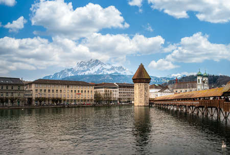 LUZERN, SWITZERLAND - APRIL 11:Chapel bridge famous place on lake Luzern with snow mountain behide, APRIL 11,2015, Lucerne, Switzerland. Chapel bridge famous place on lake Lucerne Switzerland, Europe.のeditorial素材