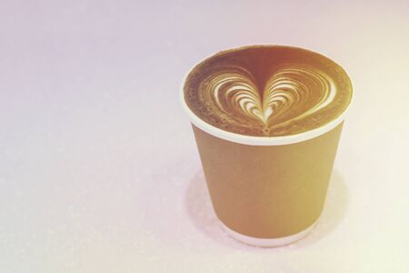 cup of cappuccino with foam in the form of heartの写真素材