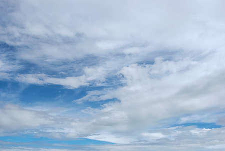 blue sky with white, soft cloudsの写真素材