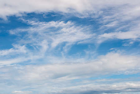 blue sky with white, soft cloudsの写真素材