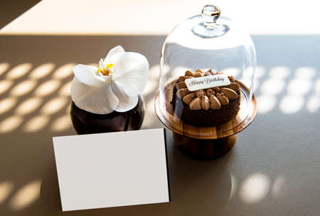 Chocolate birthday cake over a brown backgroundの写真素材