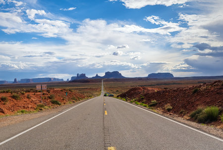 Long road in Monument Valley on the Border between Arizona and Utah, United Statesの写真素材