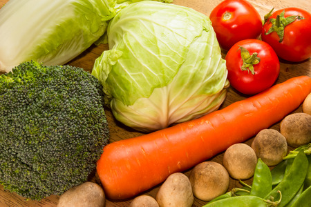 Variety of fresh vegetables on wooden tableの写真素材