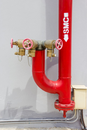 Red fire Hydrant with water hosesの写真素材