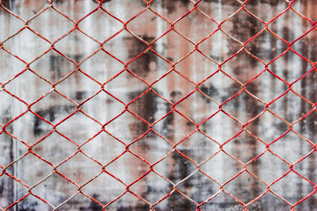 Chainlink fence against wall backgroundの写真素材