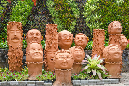 The strange jardiniere sculpture look like human face in Nong Nooch tropical garden in Pattaya, Thailand.の写真素材