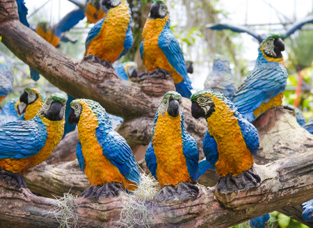 The synthetic parrot as garden decoration in Nong Nooch tropical garden in Pattaya, Thailand.の写真素材