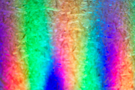 High key blurred image of pressboard background with colorful light