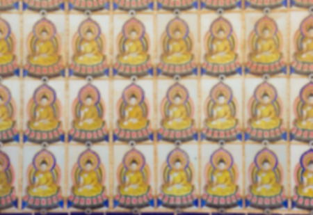 out of focus many buddha on wallの写真素材