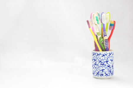 used toothbrush in cup on backgroundの写真素材