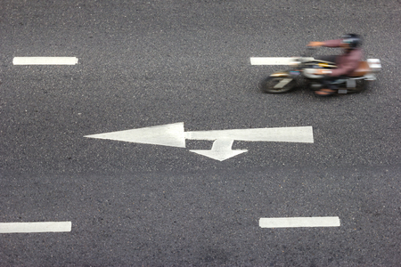 high angle of the road with white arrow,motion blur of motorcycle