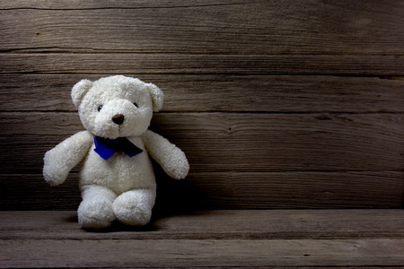 Teddy bear  on wood background, still lifeの写真素材