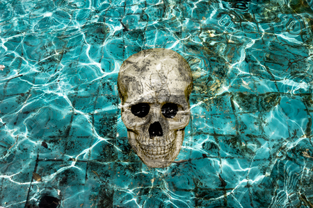 haunting pool with skullの写真素材