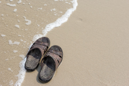 Old sandals on the beachの写真素材