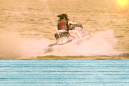 Wooden table with girl on jet ski,blurred background,filter effect,