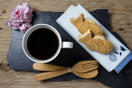Taiyaki cakes with coffee on wood backgroundの写真素材