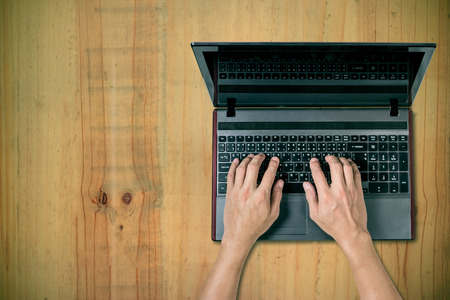 man using laptop on deskの写真素材