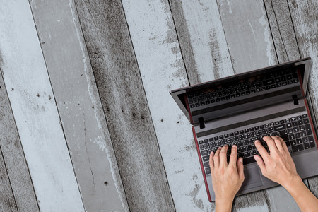 man using laptop with gray wood backgrounds