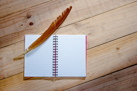 open note book with feather penの写真素材