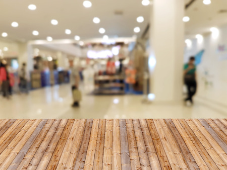Wooden table with shopping mall blurred backgroundの写真素材
