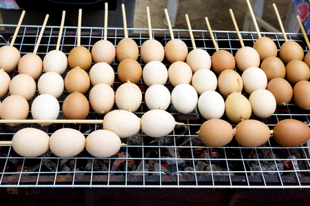 Grilled eggs with stick on stoveの写真素材