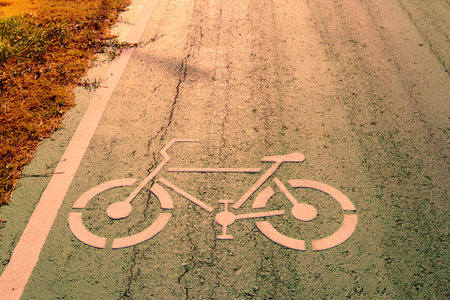 Bicycle symbol on city street with morning sunlightの写真素材