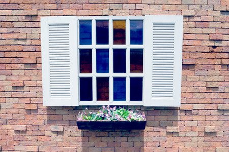 White wooden window and Flower pot on brick wall background,filter effectの写真素材