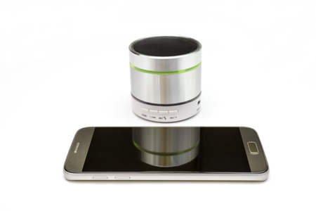 cellphone and silver speaker isolated on white backgroundの写真素材