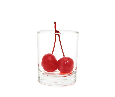 Maraschino cherry in glass cup isolated on white backgroundの写真素材