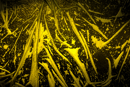 wet plastic film on black background,Golden toneの写真素材