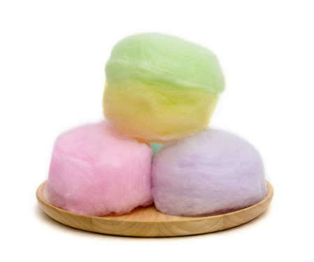 cotton candy on wooden dish isolated on white backgroundの写真素材