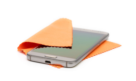 Smartphone cleaning dirty screen with orange fabric,isolated on white backgroundの写真素材