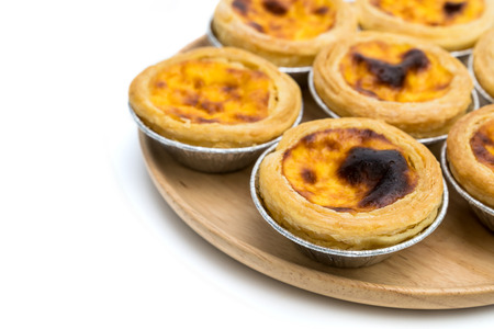 egg tart in aluminum foil cup isolated on white backgroundの写真素材