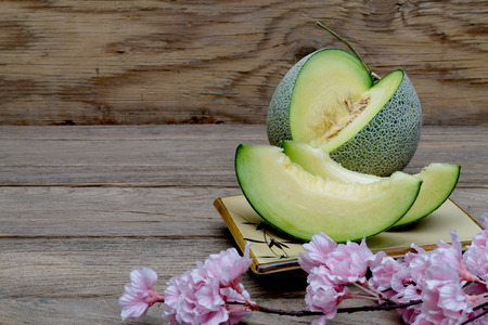 melon sliced on wooden background