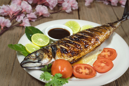 Grilled Mackerel Fish with sauce and vegetablesの写真素材