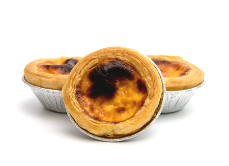 egg tart in aluminum foil cup isolated on white background