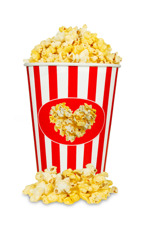 Cheese popcorn in red and white striped bucket isolated on white background with heart shapeの写真素材