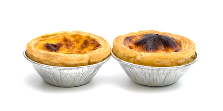 egg tart in aluminum foil cup isolated on white backgroundの写真素材