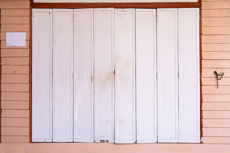 White wooden door and pink wall texture backgroundの写真素材