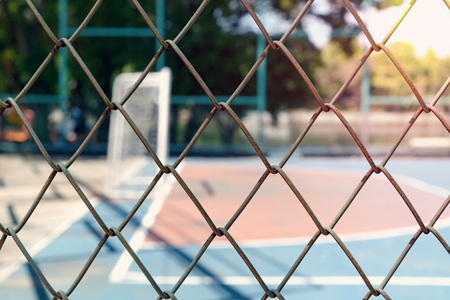 Iron net with blur football field background.の写真素材