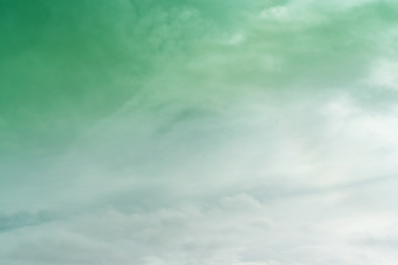 White cloud and green sky background with copy spaceの写真素材