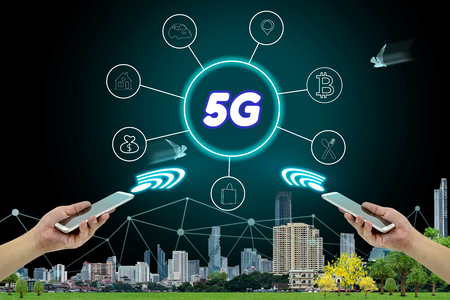 5G network interface and icon concept,hand holding mobile smart phone with cityscapeの写真素材