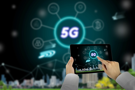 5G network interface and icon concept,businessman using tablet with cityscape backgroundの写真素材