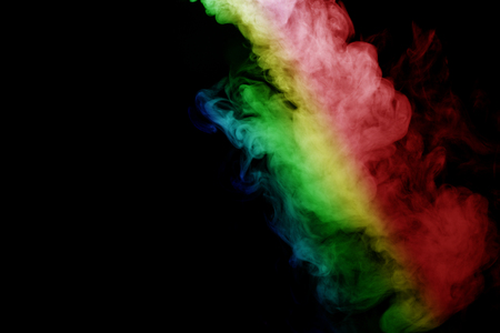 Abstract smoke isolated on black background,Rainbow powderの写真素材