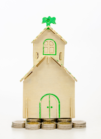 coins stacks and house on white background,business saving and investment conceptの写真素材