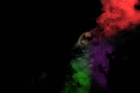 Abstract smoke isolated on black background,Rainbow powderの写真素材