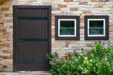 brown wooden door and window with brick wall backgroundの写真素材