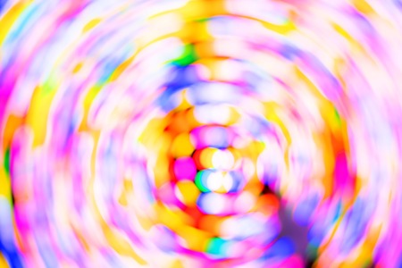 Colorful pink orange red bokeh background of Christmas lights and New yearの写真素材